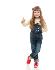 cute little girl wearing jeans overall posing in studio howing o