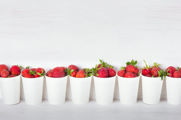 a series of white paper cups with fresh ripe delicious sweet str © iprachenko