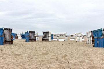 Fototapeta na wymiar beach chairs / Blue and white beach chair on the Baltic beach
