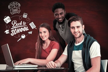 Composite image of creative team using laptop