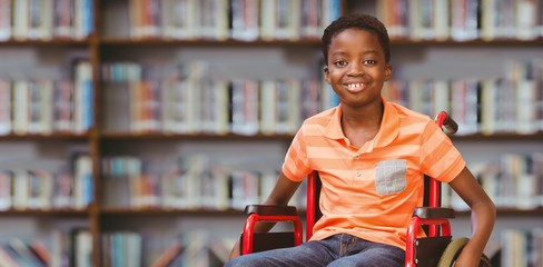 Portrait of boy sitting in wheelchair at library