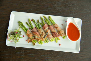  Asparagus wrapped in bacon with italian sauce