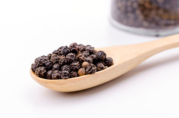 Black pepper in wooden spoon