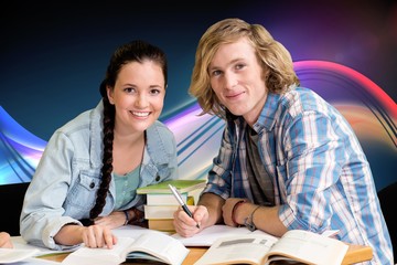 Composite image of college students doing homework in library