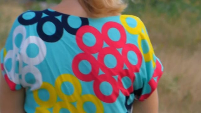 Young woman goes through a meadow