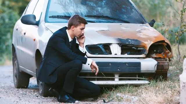 The young driver from his car burned. Concept: accident, auto