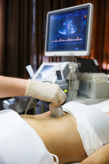 Doctor doing an ultrasound on a patient abdomen - 90546514