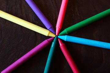 Fototapeta premium colorful Oil pastel crayons on a wooden black table