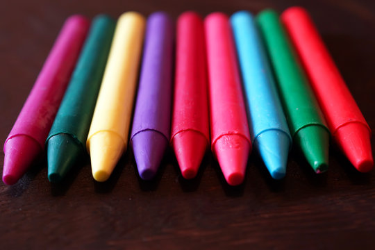 colorful Oil pastel crayons on a wooden  black table
