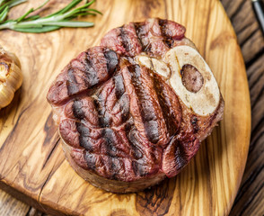 Beef steaks  with spices on a wooden tray.