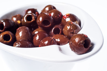 marinated brown olives in bowl