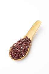 Red beans on wooden spoon isolated on white background