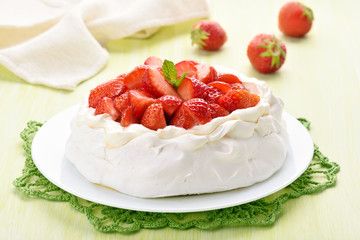 Pavlova meringue cake on white plate