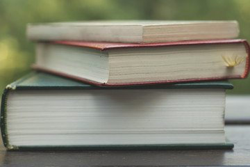 pile of books on a garden wooden table