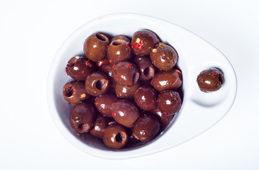 marinated brown olives in bowl