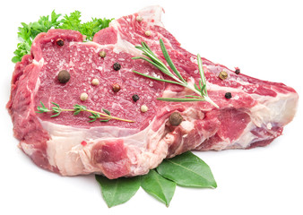 Raw beef meat steak with spices on the white background.