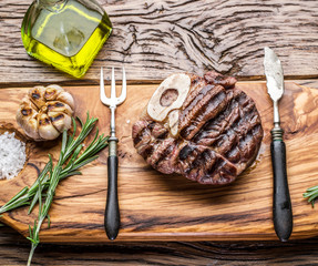 Beef steaks  with spices on a wooden tray.