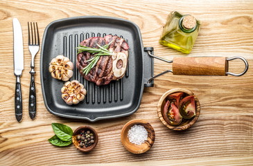 Beef steak with spices on pan.