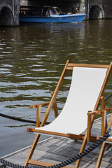 White deck chair near the canal in Amsterdam