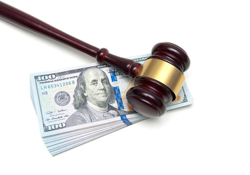 gavel and stack of US dollars on a white background
