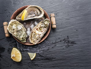 Raw oysters on the graphite board.