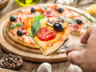 Pizza with mushrooms, salami and tomatoes.