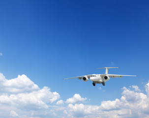 Fototapeta na wymiar White heap clouds and airplane in the blue sky.