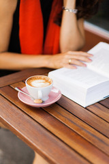 An open book and a coffee cup