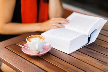 An open book and a coffee cup