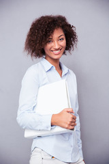 Afro american businesswoman standing with folder