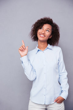 Afro american businesswoman pointing funger up