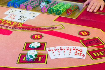 Casino Poker game. "Straight Flush" of hearts winning combination on the table.