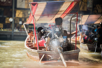 Wooden motorboat drive in floating market