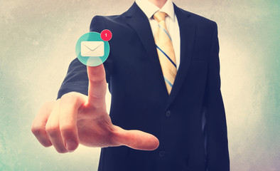 Business man pressing an email button on a blurred background