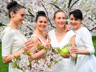 Girls with champagne celebrating in sakura's garden.