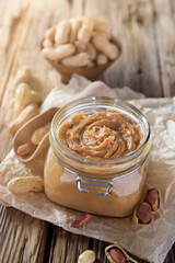 Peanut butter on wooden background.