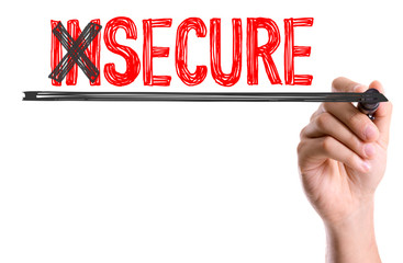 Hand with marker writing the word Insecure/Secure