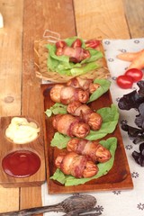 Grilled sausages wrapped in bacon fat of delicious.