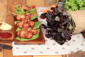 Grilled sausages wrapped in bacon fat of delicious.