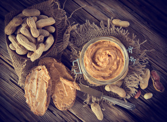 Peanut butter on wooden background.