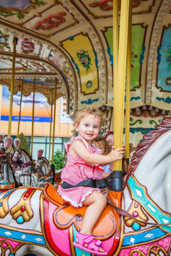 Baby girl in a carousel