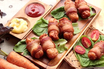 Grilled sausages wrapped in bacon fat of delicious.