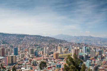 Fototapeta na wymiar Cityscape of La Paz, Bolivia with Illimani Mountain rising in th