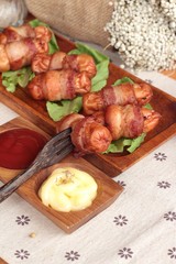 Grilled sausages wrapped in bacon fat of delicious.