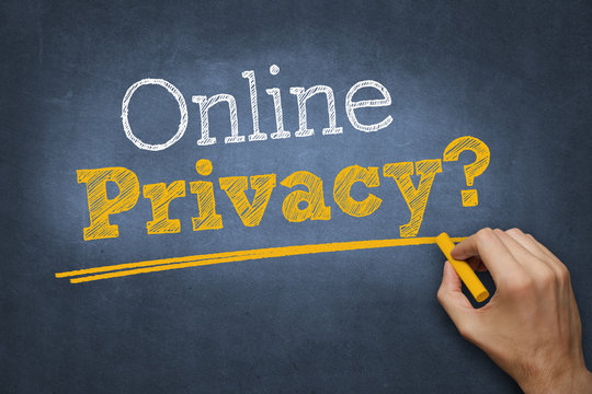 Hand Writes Chalk Text On Blackboard - Online Privacy