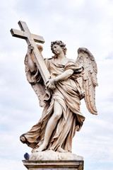 Naklejka premium Angel with the Cross statue on Ponte Sant Angelo bridge in Rome