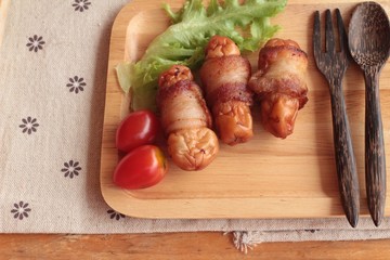Grilled sausages wrapped in bacon fat of delicious.