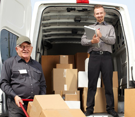 Group of delivery men near shipping truck.