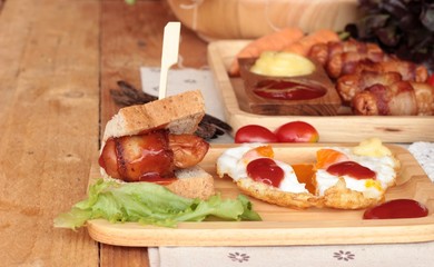 Grilled sausages wrapped in bacon fat of delicious.