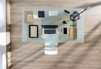 top view of a perfectly tidy glass desk